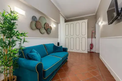 a blue couch in a living room with a guitar at Pantheon Luxury House in Rome