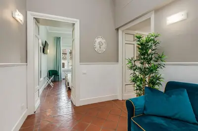 a living room with a blue couch and a plant at Pantheon Luxury House in Rome