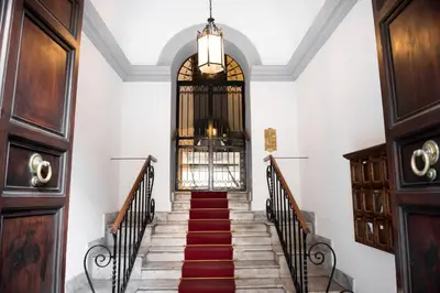 a hallway with stairs and a chandelier at Pantheon Luxury House in Rome