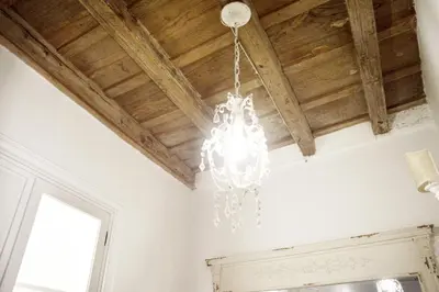a chandelier hanging from a ceiling in a room at Paradise Suite Piazza Navona Campo de Fiori in Rome