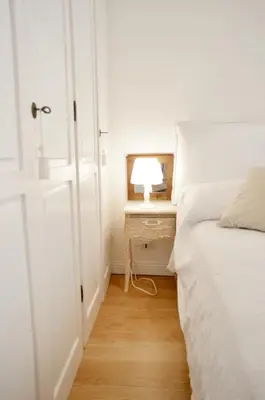 a bedroom with a bed and a table with a lamp at Paradise Suite Piazza Navona Campo de Fiori in Rome