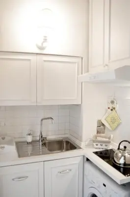 a kitchen with white cabinets and a sink at Paradise Suite Piazza Navona Campo de Fiori in Rome