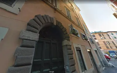 a building with a large door on the side of it at Paradise Suite Piazza Navona Campo de Fiori in Rome