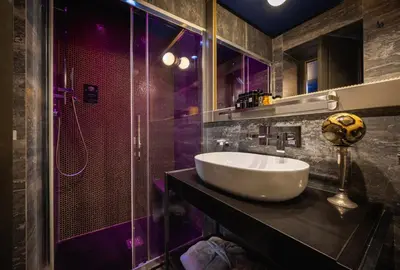 a bedroom with a large white bed and a mirror at Maison Torre Argentina in Rome