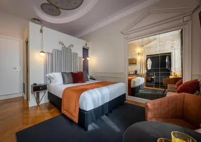 a bedroom with a large bed and a table and chairs at Maison Torre Argentina in Rome