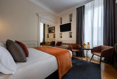 a hotel room with a bed and a table and chairs at Maison Torre Argentina in Rome