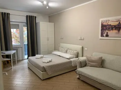 a bedroom with a bed and a couch at Residenza Romana Vaticana in Rome