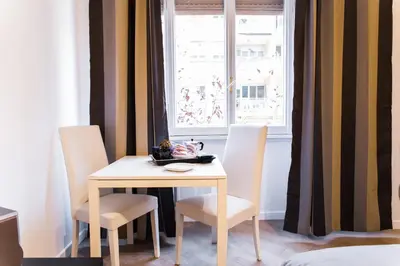 a table and chairs in a room with a window at Residenza Romana Vaticana in Rome