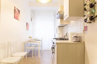 a small kitchen with a table and chairs in it at Residenza Romana Vaticana in Rome