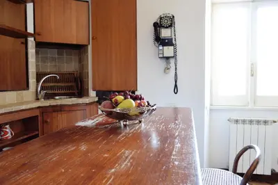 a bowl of fruit on a wooden table in a kitchen at Domus Rotundae Pantheon in Rome