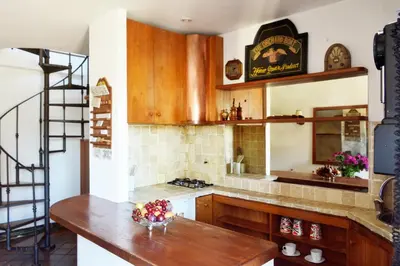 a kitchen with wooden cabinets and a wooden table at Domus Rotundae Pantheon in Rome