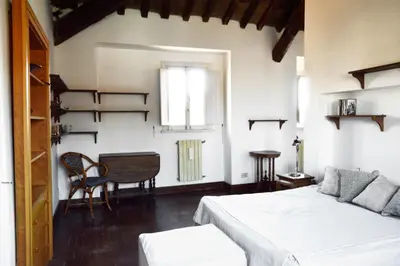 a bedroom with a bed and a table and a window at Domus Rotundae Pantheon in Rome