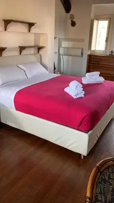 a bedroom with a large bed with a red blanket at Domus Rotundae Pantheon in Rome