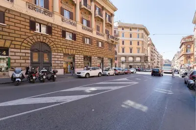 a city street with cars parked on the side of a building at Palazzo Giorgioli Apartment in Rome