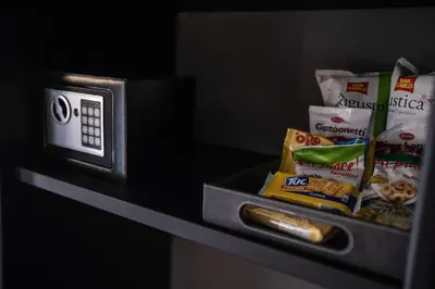 a counter with a microwave and snacks on it at Relais Manzoni in Rome