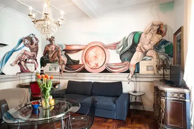 a living room with a couch and a painting on the wall at Santa Cecilia Apartment in Via del Corso in Rome