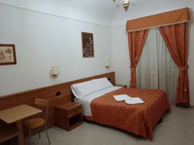 a bedroom with a bed with two towels on it at Appartamento Privato Simone in Rome