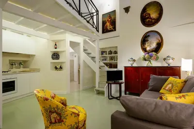 a living room with a couch and a kitchen at Navona Charming Flat in Rome
