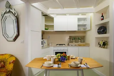 a small kitchen with a wooden table in a room at Navona Charming Flat in Rome