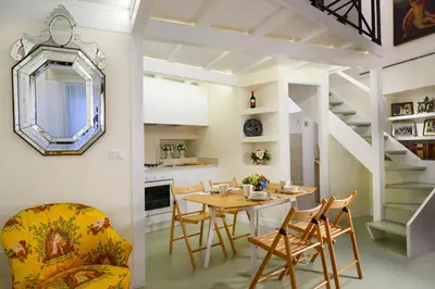a kitchen and dining room with a table and chairs at Navona Charming Flat in Rome