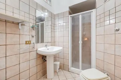 a bathroom with a toilet sink and a shower at Appartamento con 3 camere da letto e 2 bagni vicino al Vaticano in Rome