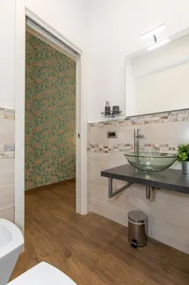 a bathroom with a sink and a mirror at Comfy Vatican Suite in Rome