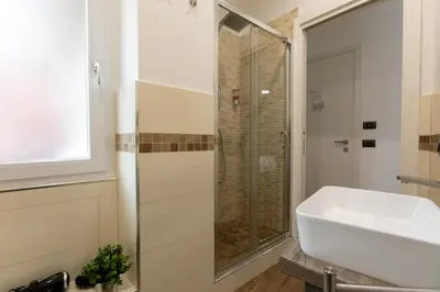 a bathroom with a sink and a shower at Comfy Vatican Suite in Rome