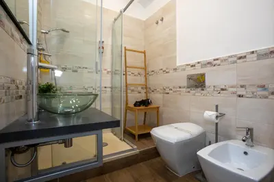 a bathroom with a sink and a toilet and a shower at Comfy Vatican Suite in Rome