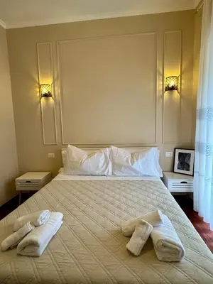 a bedroom with a bed with two towels on it at La Muraglia Di San Pietro in Rome