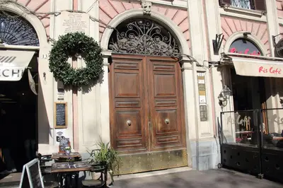a large wooden door on the side of a building at La Muraglia Di San Pietro in Rome