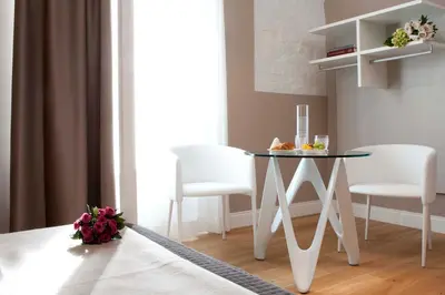 a table in a room with two chairs and a table at Cardilli Luxury Rooms in Rome