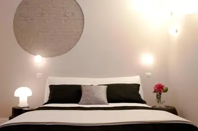 a bedroom with a large mirror above a bed at Cardilli Luxury Rooms in Rome