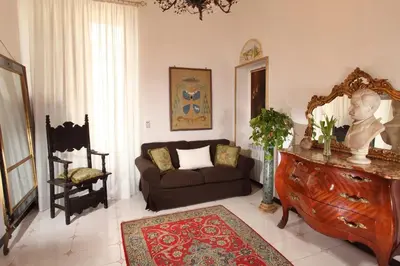 a living room with a couch and a mirror at Roma Central Guest House in Rome