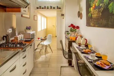 a kitchen with a counter with food on it at Roma Central Guest House in Rome