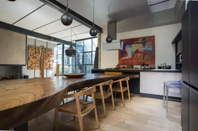 a kitchen with a large wooden table and chairs at Loft Spazio Panieri Unique place in Trastevere in Rome
