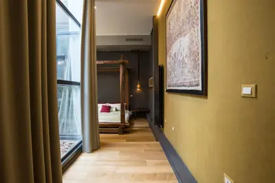 a hallway with a room with a bed and a window at Loft Spazio Panieri Unique place in Trastevere in Rome