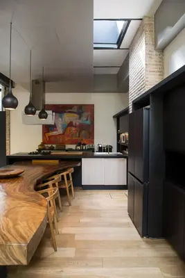 a kitchen with a wooden table and a dining room at Loft Spazio Panieri Unique place in Trastevere in Rome