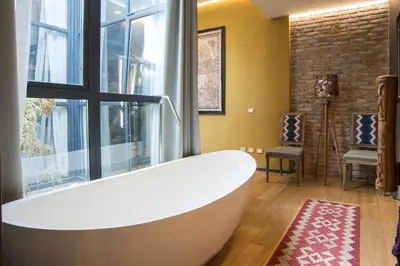 a bath tub in a bathroom with a window at Loft Spazio Panieri Unique place in Trastevere in Rome