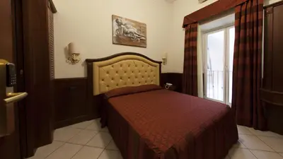 a bedroom with a bed and a window at Domus Augusta in Rome