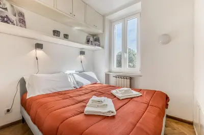 a bedroom with a bed with two towels on it at Giulia's holidays in Rome