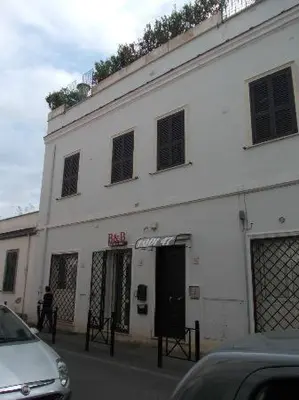 a white building with a car parked in front of it at Residence Lodi in Rome