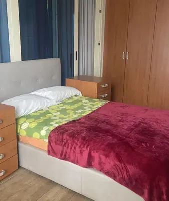 a bedroom with a bed with a purple blanket at Residence Lodi in Rome