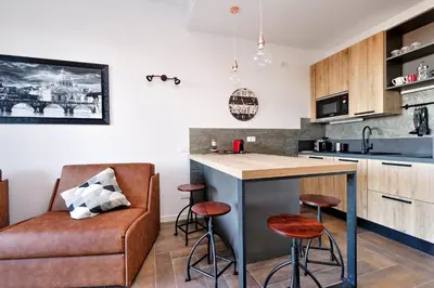 a kitchen with a couch and a bar with stools at YCH-DELIZIOSO Monolocale con TERRAZZO in Rome