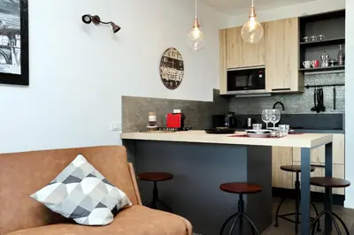 a kitchen with a counter and a bar with stools at YCH-DELIZIOSO Monolocale con TERRAZZO in Rome