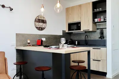 a kitchen with a large island with stools at YCH-DELIZIOSO Monolocale con TERRAZZO in Rome