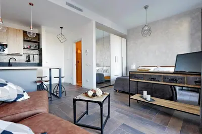 a living room with a couch and a table at YCH-DELIZIOSO Monolocale con TERRAZZO in Rome