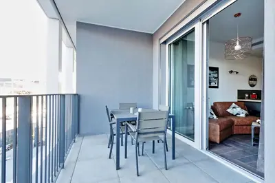 a balcony with a table and chairs and a couch at YCH-DELIZIOSO Monolocale con TERRAZZO in Rome