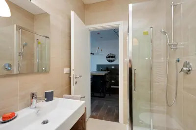 a bathroom with a white sink and a shower at YCH-DELIZIOSO Monolocale con TERRAZZO in Rome