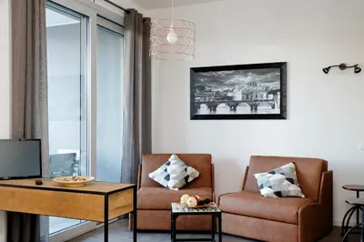 a living room with a couch and a chair at YCH-DELIZIOSO Monolocale con TERRAZZO in Rome