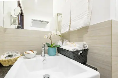 a bathroom with a sink and a mirror at Suite 36 in Rome
